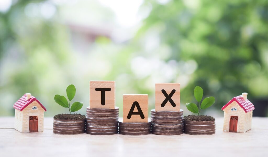 Wood blocks spelling tax on top of quarters