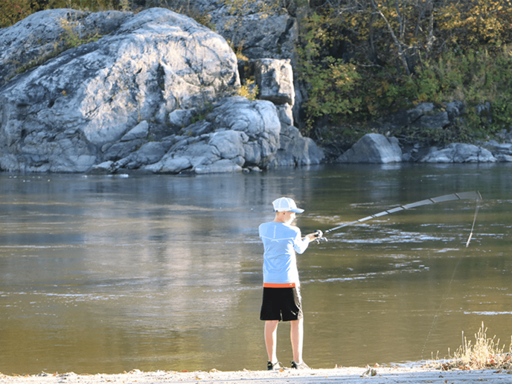 Boy fishing on a river